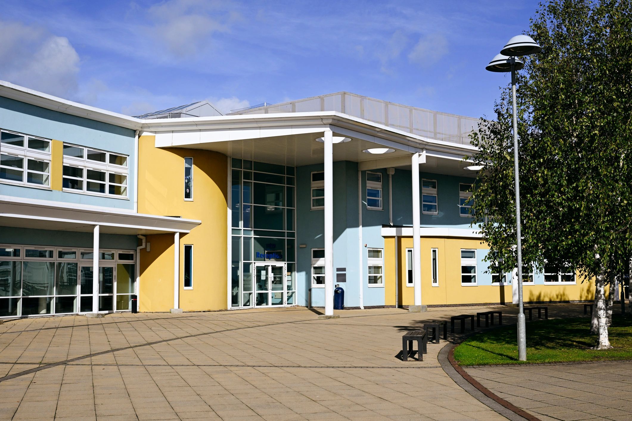 Well-maintained institutional building exterior representing facilities support